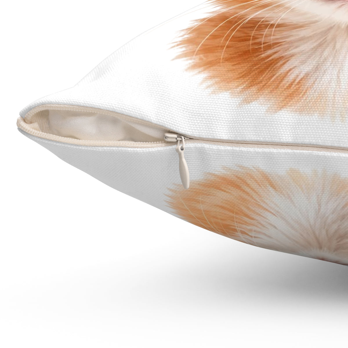 Close-up of a white throw pillow with a soft orange and cream feather print, showing the zipper closure.