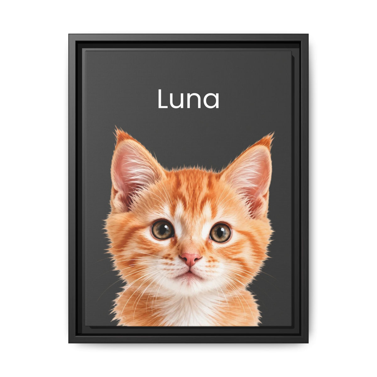 A framed custom pet portrait featuring a close-up photo of an orange tabby kitten on a dark charcoal background with the name 'Luna' printed in white at the top. The print is housed in a simple black frame and is shown against a clean white background.