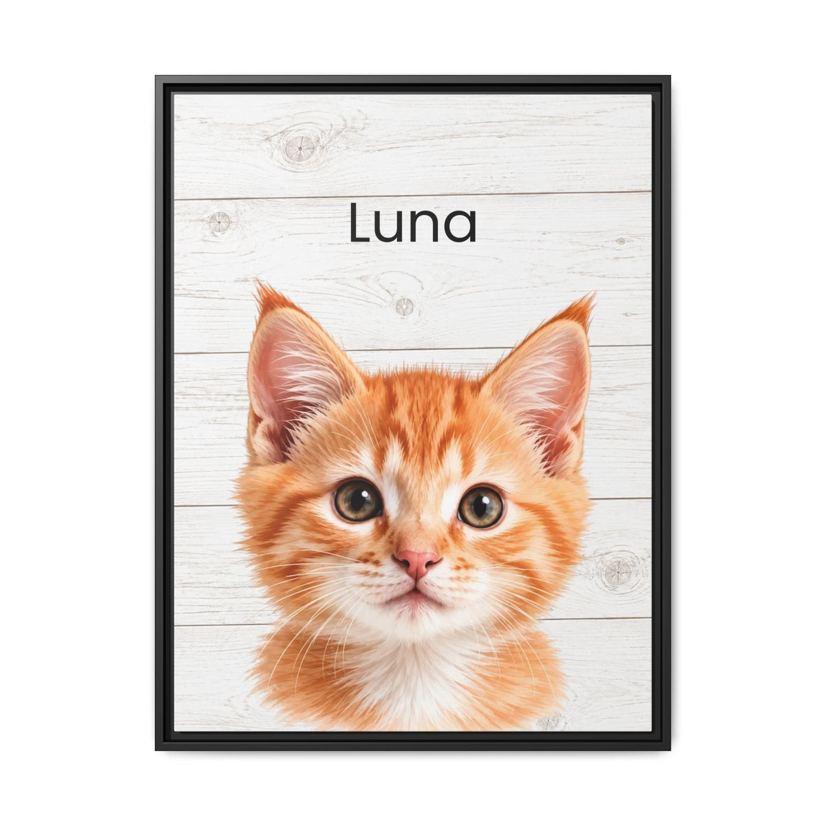 A framed custom pet portrait featuring an orange tabby kitten on a white wood plank background with the name 'Luna' printed above it, enclosed in a thin black frame.