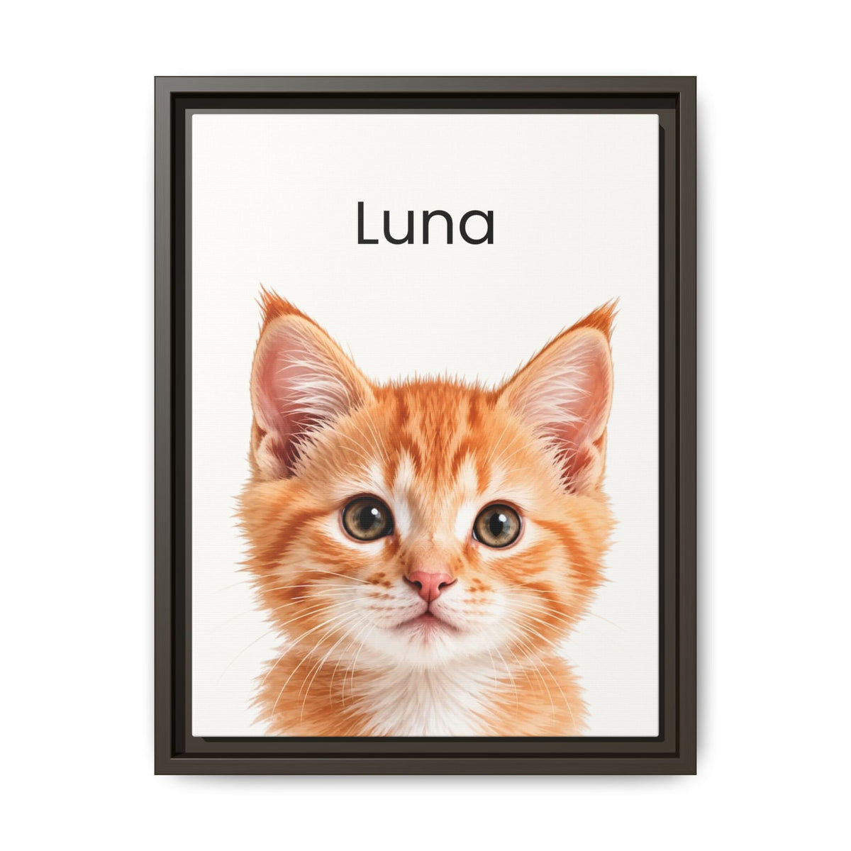 A framed custom pet portrait featuring a close-up photograph of an orange tabby kitten with the name 'Luna' printed above it, set in a dark frame against a white background.