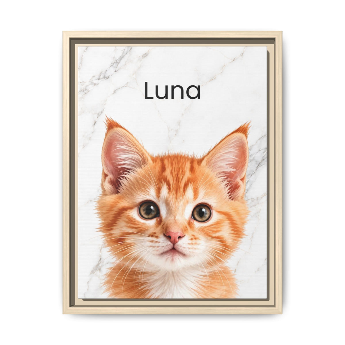 A framed custom pet portrait featuring an orange tabby kitten on a white marble background with the name 'Luna' printed at the top, set in a light wood frame.