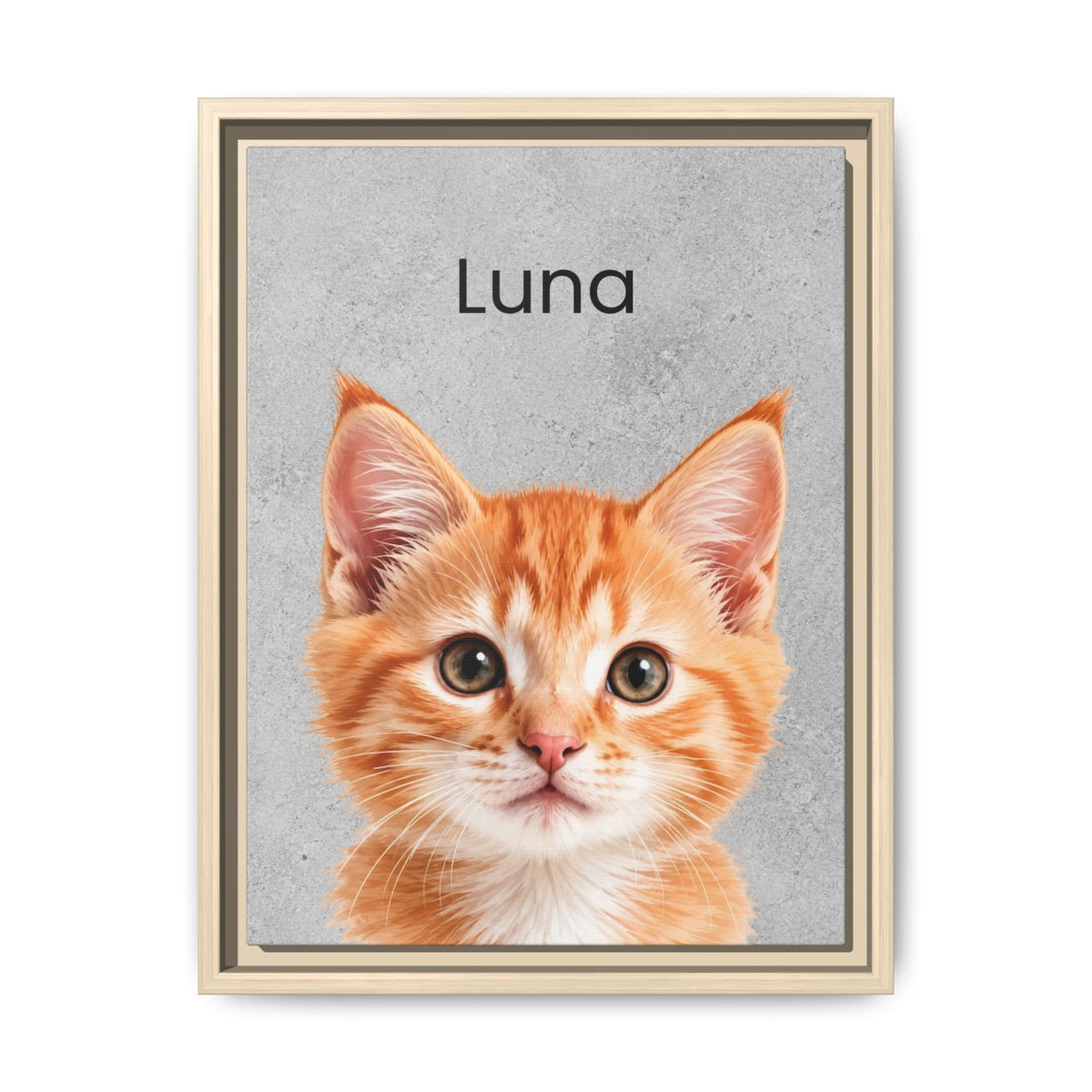 A framed custom pet portrait featuring a close-up photo of an orange tabby kitten with the name 'Luna' printed above it on a textured gray background, enclosed in a light wood frame.