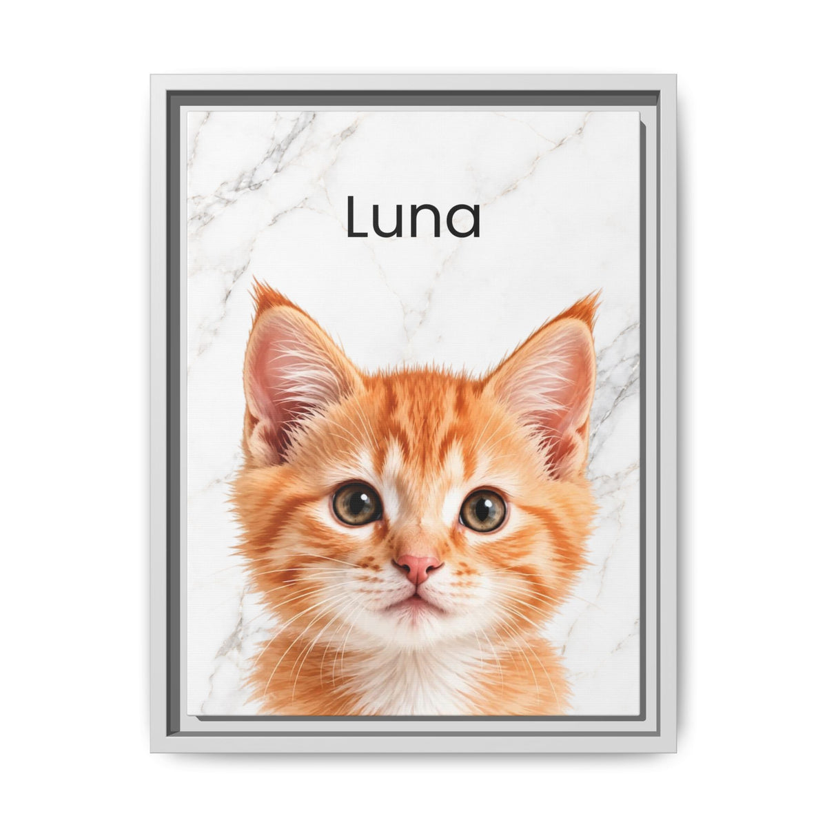 A custom framed pet portrait featuring a close-up photo of an orange tabby kitten on a white marble background with the name 'Luna' printed at the top. The frame is white with a thin gray inner border, shown against a clean white background.