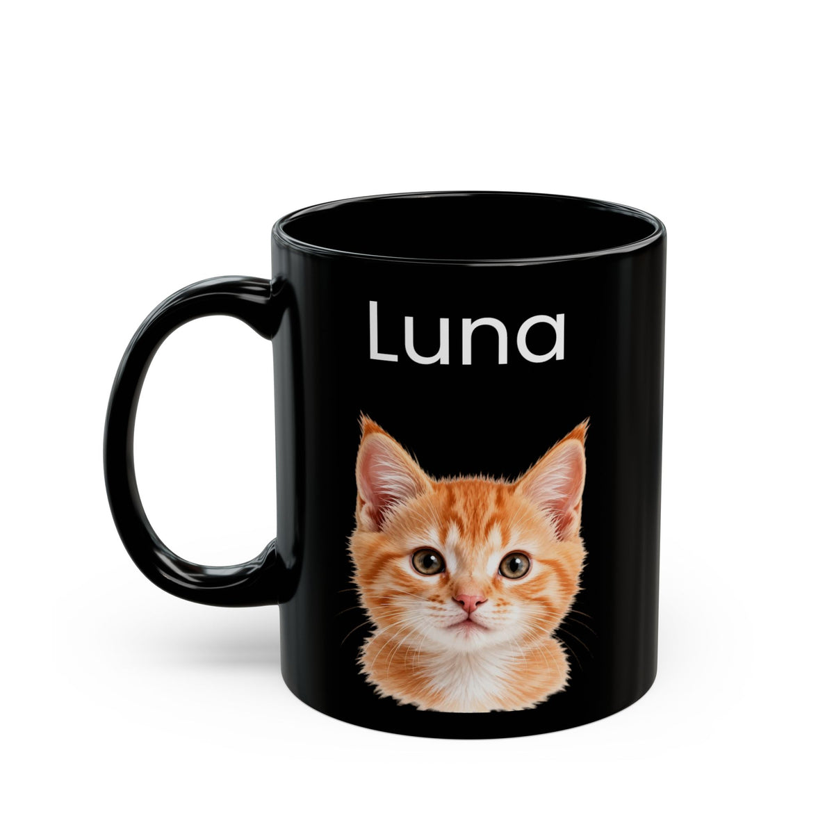 A black ceramic mug featuring a printed design of an orange tabby kitten and the name 'Luna' in white text, shown on a clean white background.